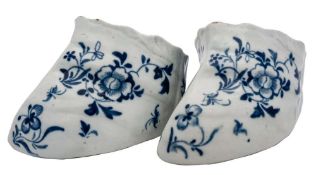 A pair of Liverpool blue and white stirrup cups: painted with insects and peony sprays,