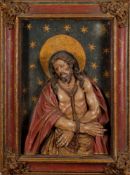 A 17th Century and later carved wood and polychrome decorated high relief panel: depicting Christ