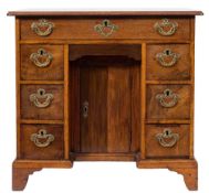 A mid 18th Century mahogany kneehole desk:, of small size, the top with a moulded edge,