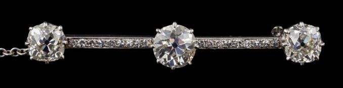 A diamond mounted bar brooch: with three principal old-cut diamonds, approximately 1.0cts, 1.