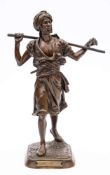 After Emile Pinedo (1840-1916) 'Arabe en marche': a bronze study of an Arab walking with a long