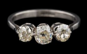 A diamond three-stone ring: set with cushion-shaped old brilliant-cut diamonds approximately 0.
