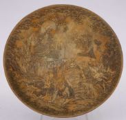 A Japanese brass dish: decorated in low relief with four figures below a seated Buddha with dragon