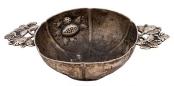 A Continental silver wine taster, unmarked: of lobed circular form, with embossed fruit decoration,