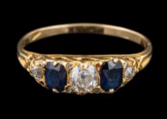 A sapphire and diamond five-stone ring: set with old brilliant-cut diamonds between oval sapphires