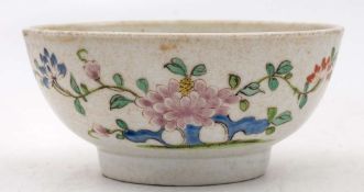 A Plymouth polychrome bowl: painted with peony sprays, an insect and pierced blue rockwork,