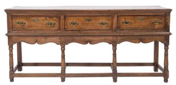 An 18th Century and later oak rectangular dresser base:, the top with a moulded edge,