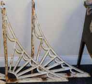 A pair of cast iron wall brackets: of L-shaped outline with fan spandrel decoration, 76cm x 60cm.