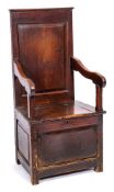 An 18th Century oak box seat armchair:, with a rectangular fielded panel back,