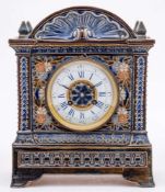 A Doulton Lambeth stoneware cased mantel clock: of architectural outline incised with flowers,