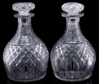 A pair of mid 19th century heavy cut glass decanters and mushroom stoppers: with horizontal cut