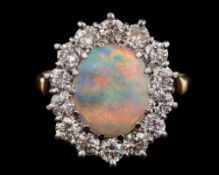 An opal and diamond oval cluster ring: with central oval opal approximately 11mm long x 9mm wide,