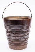 A 19th Century Dutch carved walnut bucket: of cylindrical tapering form,