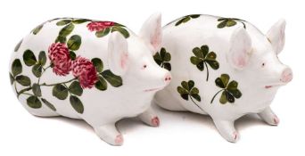 Two Bovey Tracey Wemyss pottery pigs: of small stature and in seated posture,