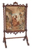 A Victorian mahogany barley twist fire screen with needlework panel.