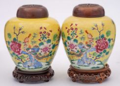 A pair of Chinese famille rose yellow ground ginger jars: each painted with a phoenix perched on