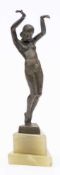 Stefan Dakon An Art-Deco bronze figure: depicting a nude female on tip-toes with her hands raised