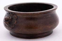 A Chinese bronze censer: of squat circular form with stylized dragon mask decorated handles to the