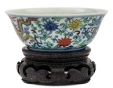 A small Chinese doucai porcelain bowl: the exterior enamelled with a pair of dragons amongst