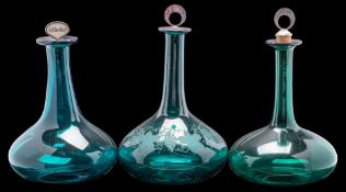 A group of three 19th century green glass Mel bottles and stoppers: each of compressed form with