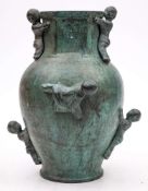 A 20th Century Chinese bronze 'Boy' vase: of ovoid outline, with a hexagonal neck and rim,