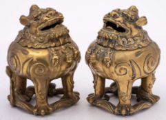 A pair of Chinese bronze incense burners in the form of Qilins: each beast with hinged head and