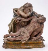 An 18th Century Continental carved wood and polychrome decorated figure group,