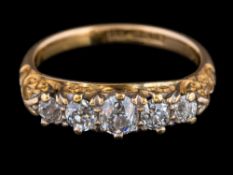 A gold and graduated diamond five-stone ring: set with round old brilliant-cut diamonds estimated