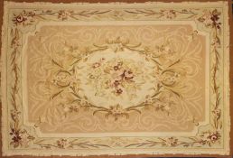 An Aubusson tapestry:, the cream and beige field with a central bouquet of flowers and foliage,