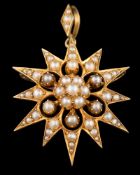 A late 19th /early 20th Century gold and seed pearl star burst pendant brooch: approximately 29mm
