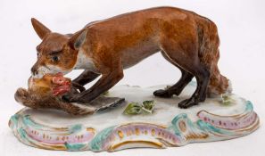 A Meissen figure of a fox and chicken: the standing fox with a chicken in its mouth,