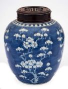 A Chinese porcelain jar: of oviform painted in blue with prunus below a narrow notched band,