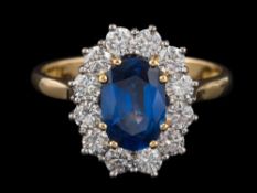 A sapphire and diamond oval cluster ring: with central oval sapphire approximately 8.5mm x 6.