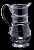 A mid 19th century French glass harvest jug: with ringed neck and loop handle,