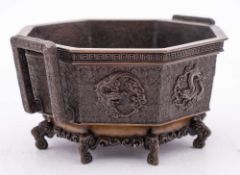 A Japanese bronze octagonal jardiniere, signed Seimen: with angular handles,