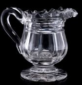 A mid 19th Century heavy cut-glass cream jug: on star-cut foot, circa 1840, 14cm.