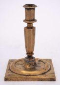 A late 17th/early 18th Century Spanish brass candlestick: with plain cylindrical nozzle on an