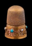 A 15ct gold, turquoise and seed pearl set thimble: with applied wirework frieze decoration, cased.