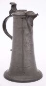 A German pewter flagon: with scroll thumbpiece and rounded flared base,