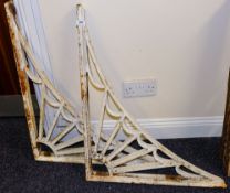 A pair of cast iron wall brackets: of L-shaped outline with fan spandrel decoration, 76cm x 60cm.