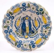 A Dutch Royal portrait delft dish: of lobed form, painted in blue,