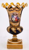 An English porcelain pedestal vase: of trumpet shaped form with 'frill' rim on a squat globular