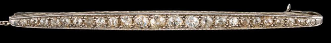 A white metal and diamond mounted line brooch: millegrain-set with graduated,