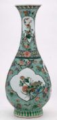 A Chinese famille verte pear-shaped bottle vase: decorated with cartouche,