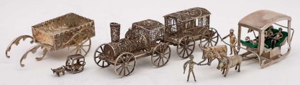 A silver filigree model of a miniature steam locomotive and tender, unmarked: 13cm long,