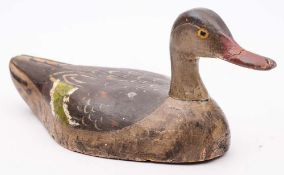 A carved wood and polychrome decorated decoy duck: possibly a Teal, overall length 35cm. long.