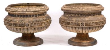 A pair of Edwardian stoneware circular pedestal garden urns:, the bodies with moulded top,