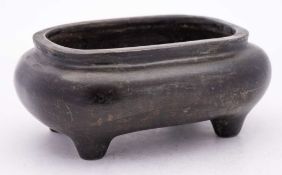 A Chinese bronze censer: of squat ovoid form, raised on four peg feet,
