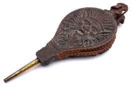 A pair of early 19th Century carved oak bellows: one side decorated in relief with a grotesque mask,