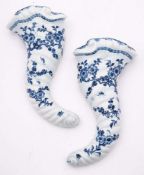 A pair of First Period Worcester blue and white cornucopiae wall pockets: of spiral moulded form,